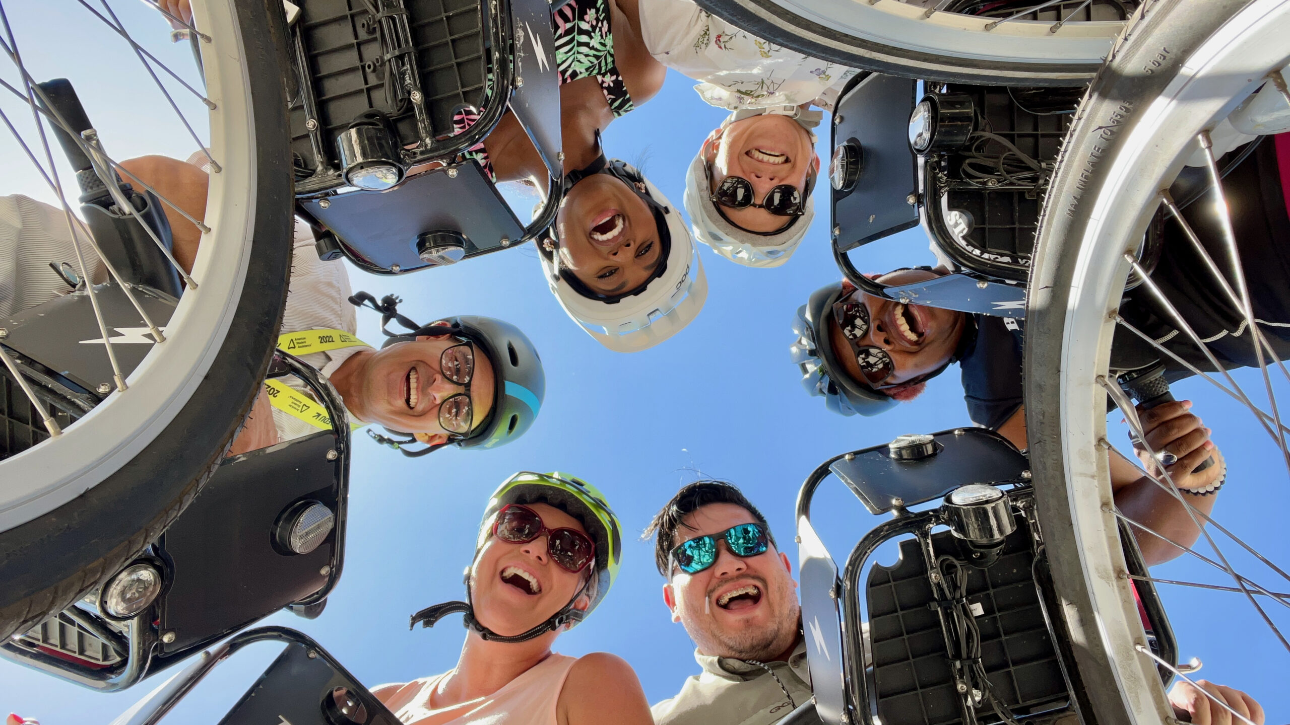 group of happy people on bike share bicycles