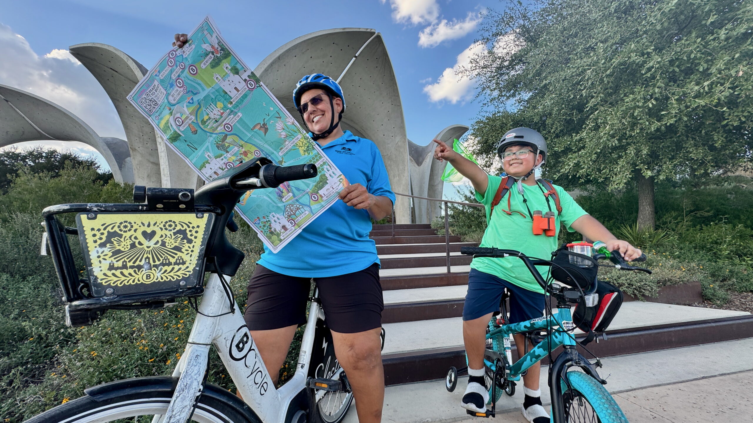 Mom and son looking at map before they ride bike share bicycles