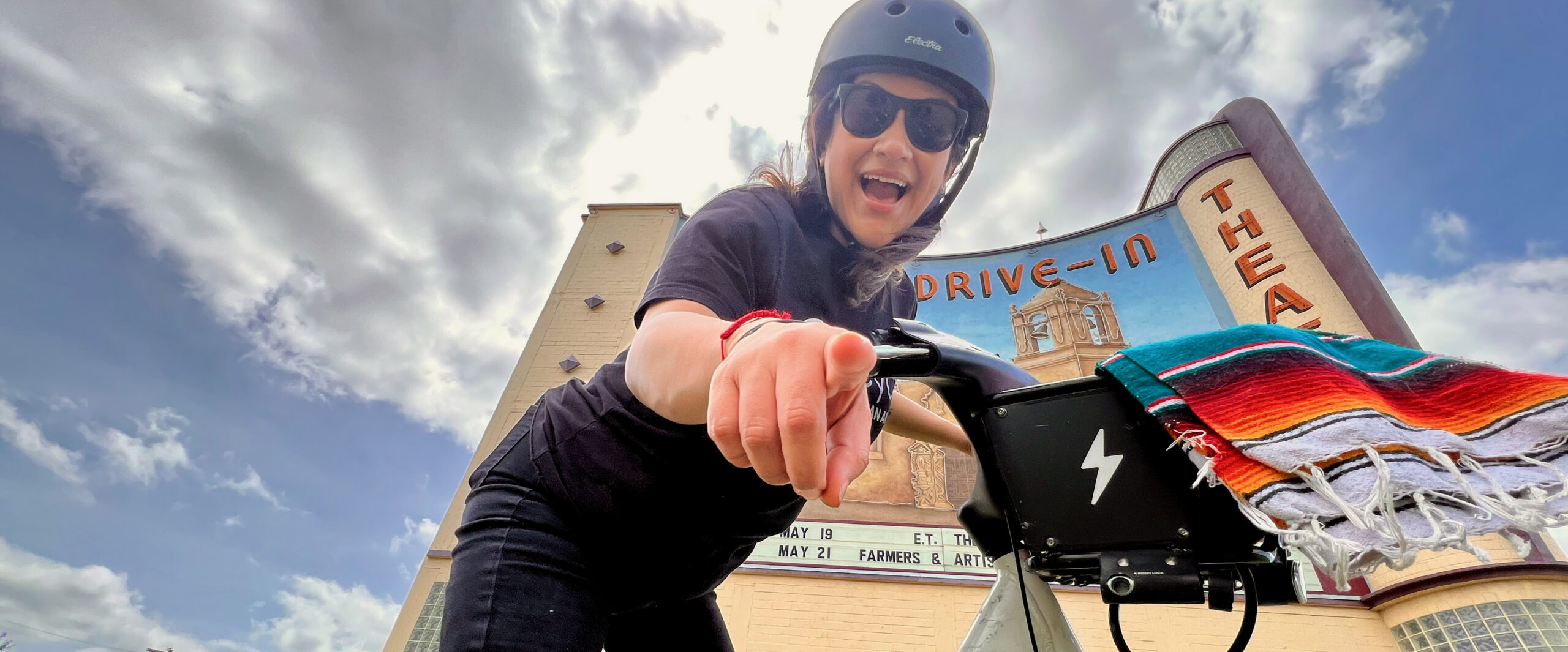 Latina woman riding a bike share bicycle