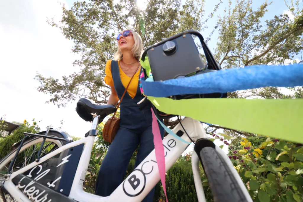 Happy lady with a bike share bicycle
